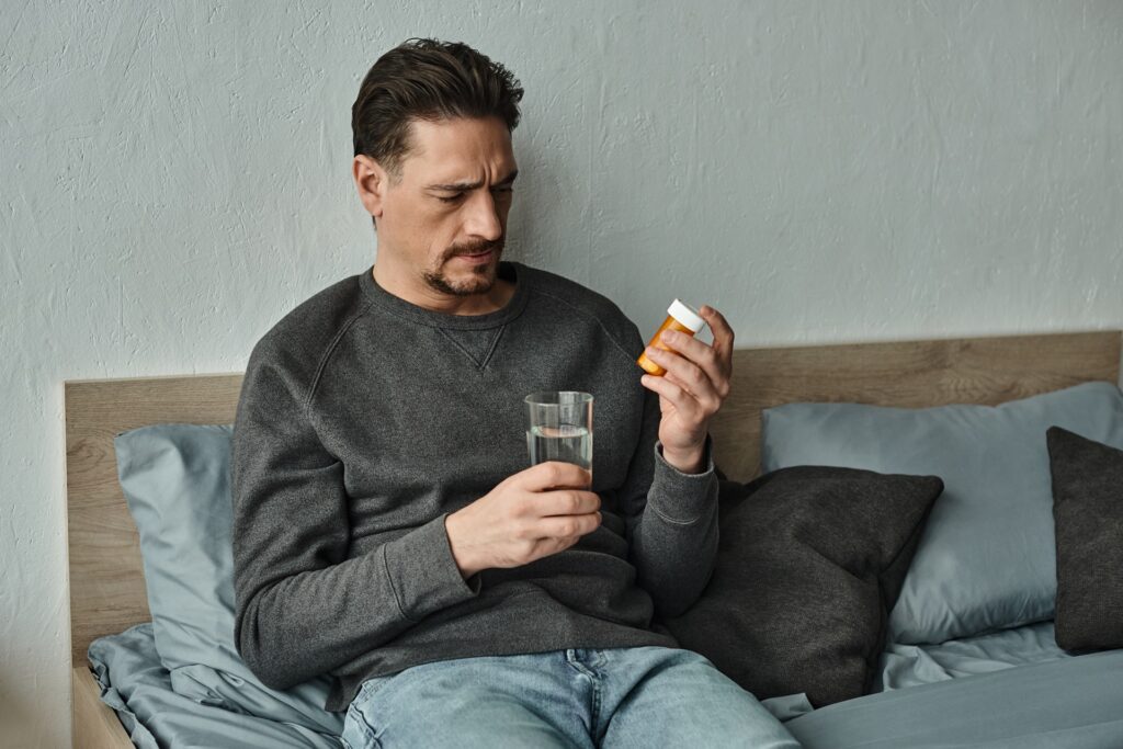 bearded man in sweater holding glass of water and 2024 02 27 20 51 22 utc