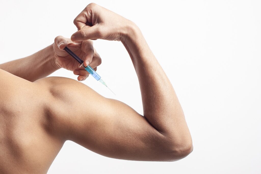 man injecting hormone steroid syringe on his bicep 2023 11 27 05 21 50 utc