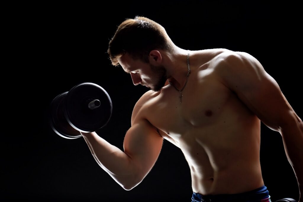 muscular man doing dumbbell exercises 2023 11 27 05 37 23 utc